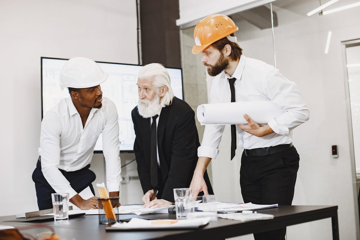 Engineering team reviewing pull requests on a shared screen in a meeting room