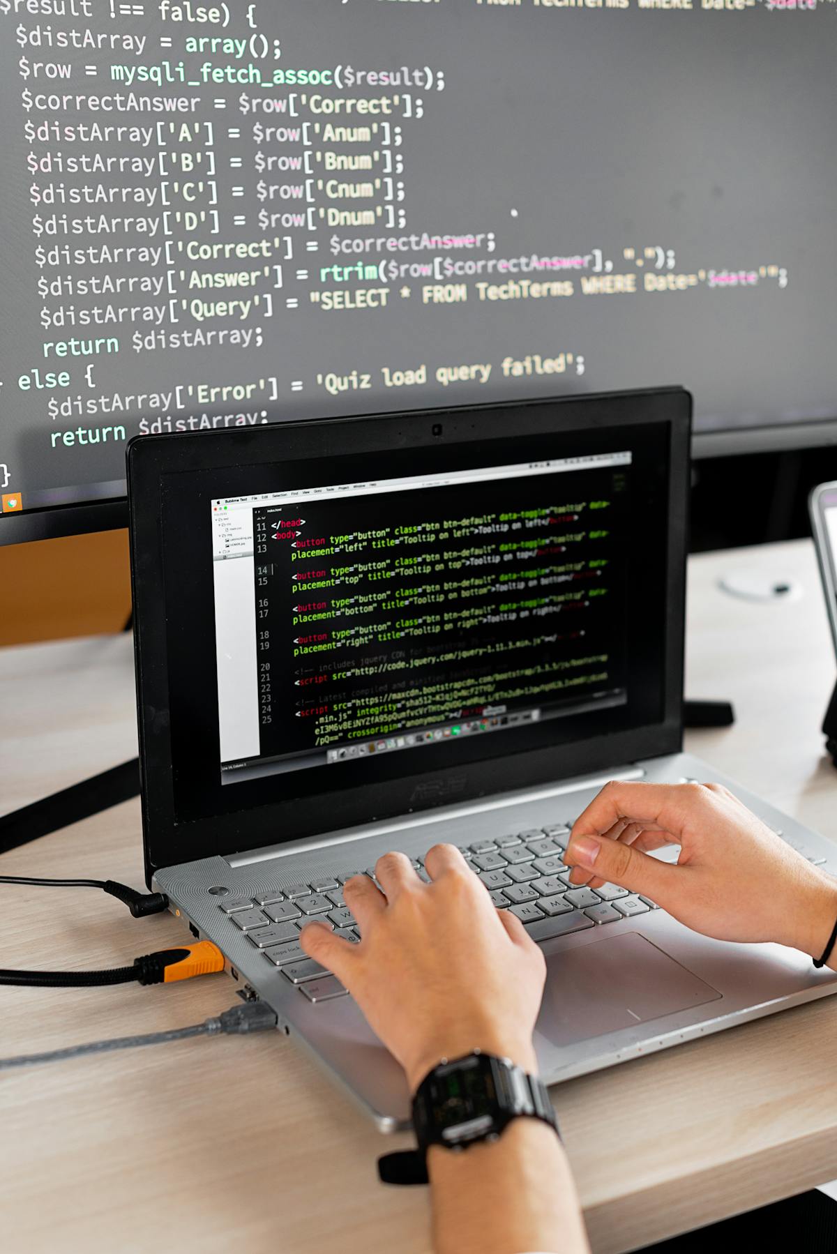 Firmware engineer reviewing code on a monitor next to embedded development hardware