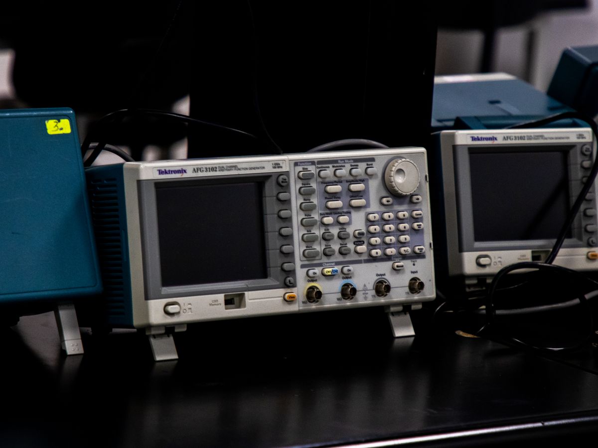 Bench instruments racked side by side in a connected product hardware lab